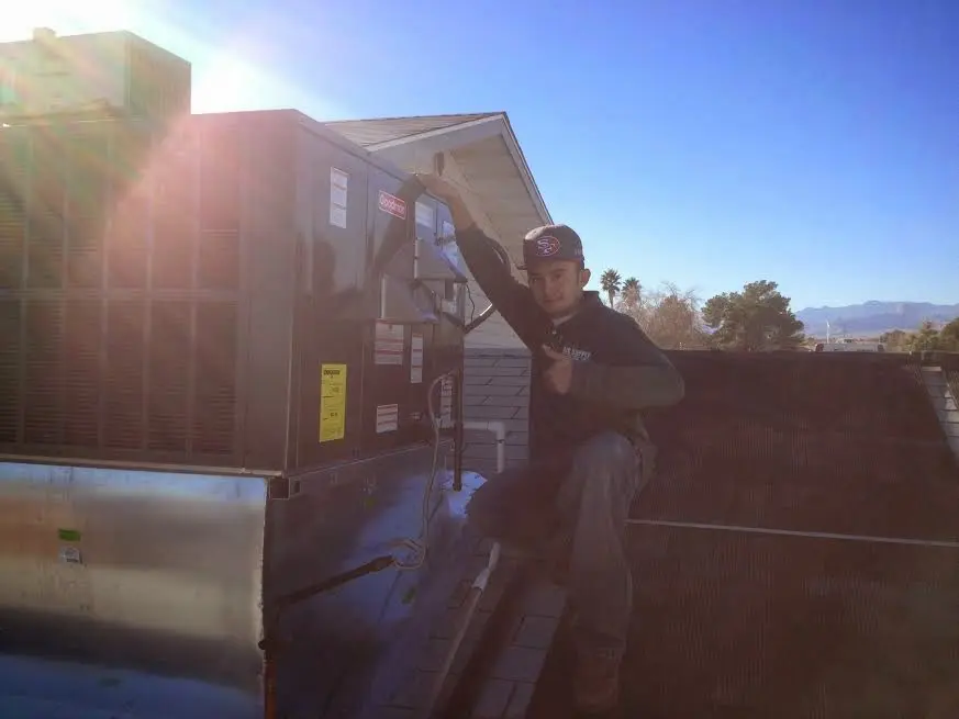 HVAC technician performing HVAC Inspection on a rooftop unit in Los Ranchos de Albuquerque